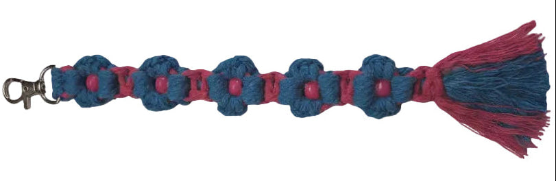 A handmade macrame 9" daisy keychain featuring alternating teal and hot pink knotted flower shapes with small pink beads in the centers, finished with a silver lobster clasp at the top and a tassel at the bottom, shown against a plain light background.